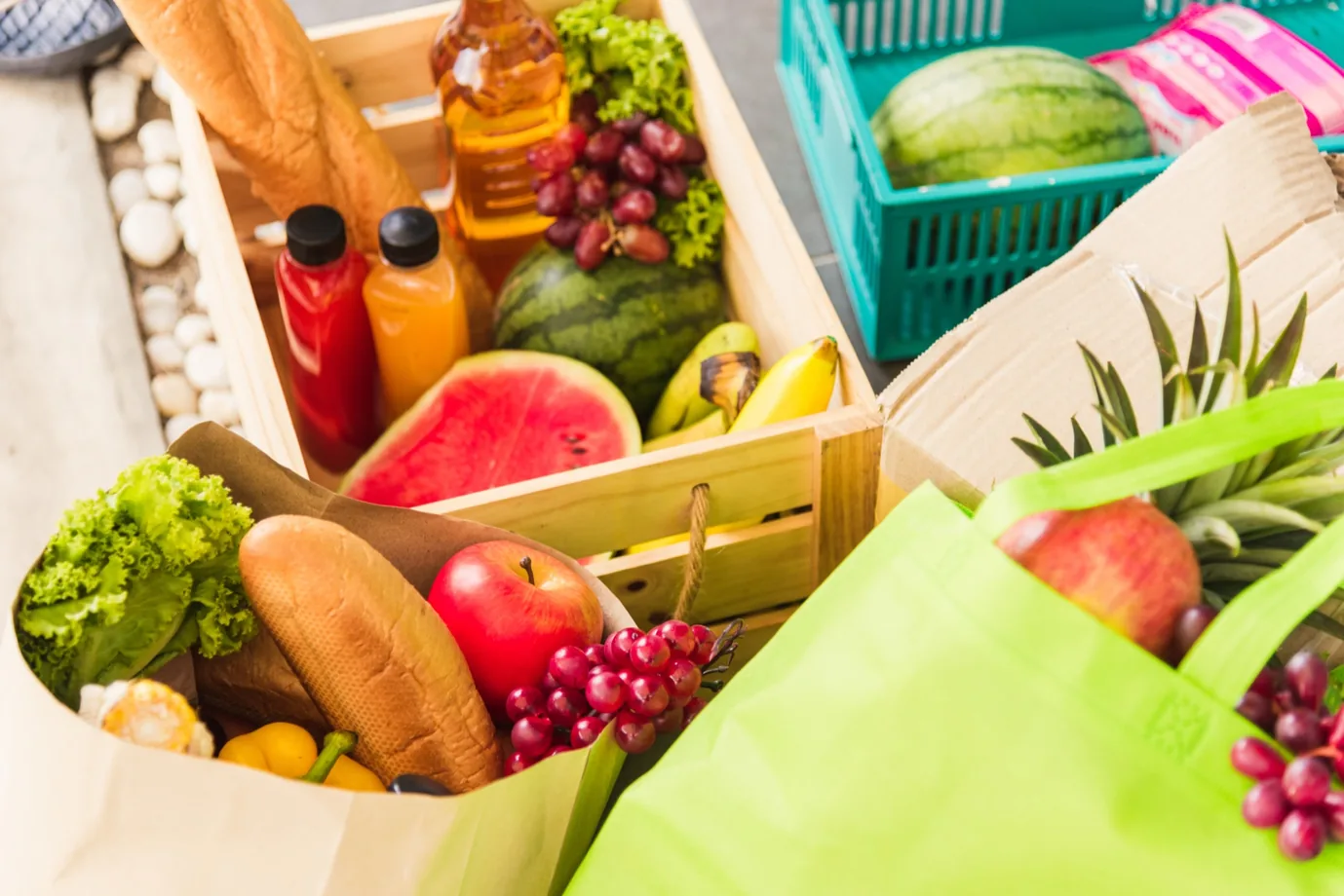 Grocery delivery driver handing over crates at a customer doorstep
