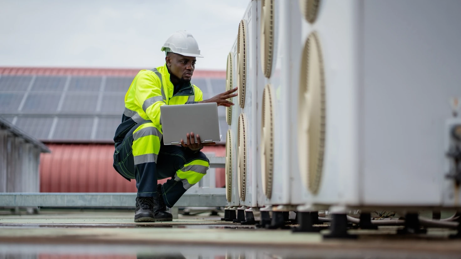 HVAC engineer servicing a commercial heating and cooling unit