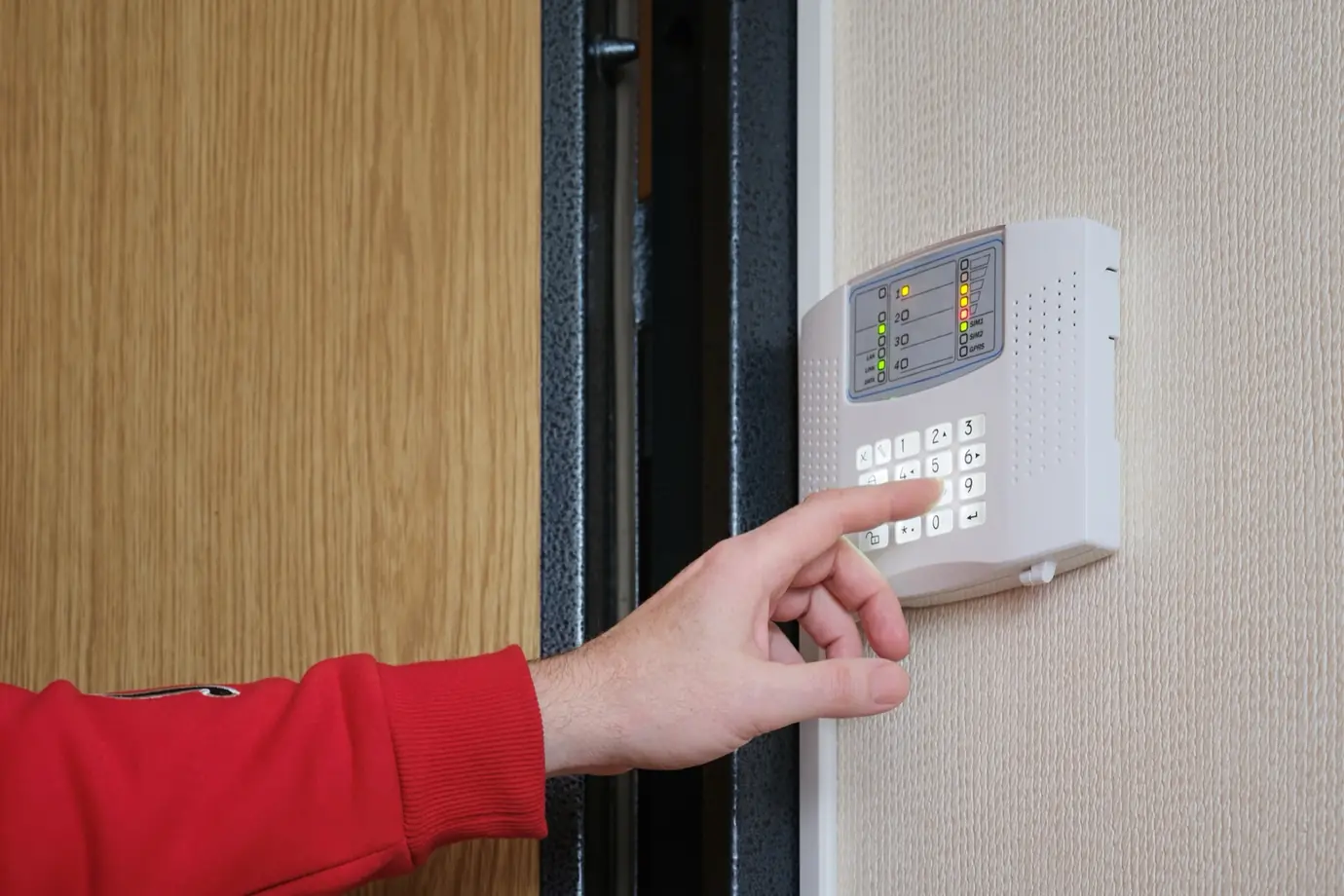 Security alarms engineer fitting a commercial alarm system