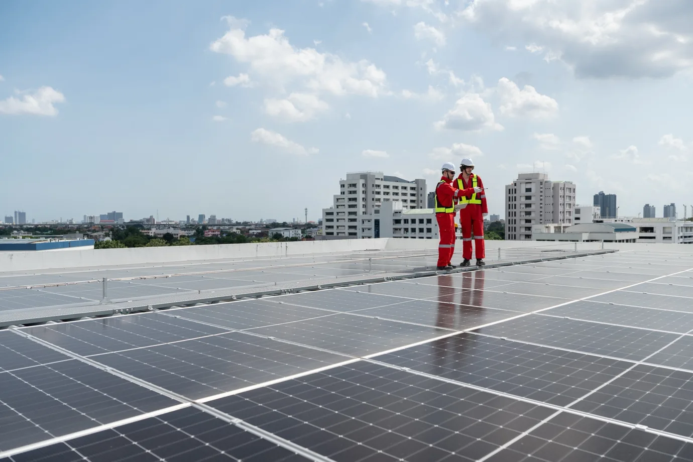 Solar installation team mounting panels on a commercial roof