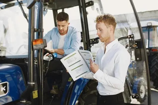 field service technician doing a safety check for a tractor