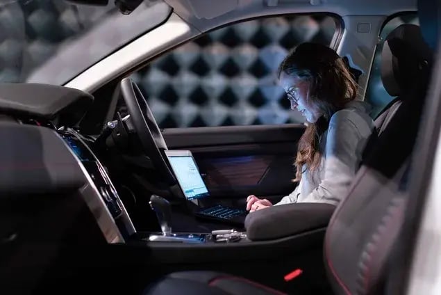field technician in the automotive industry running diagnostics on a car