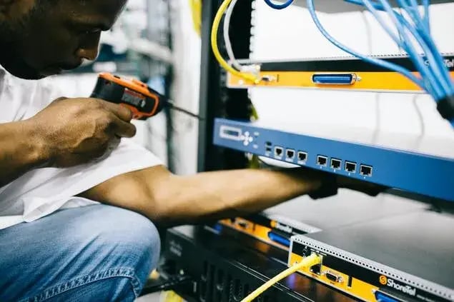 field service engineer working on site fixing it systems