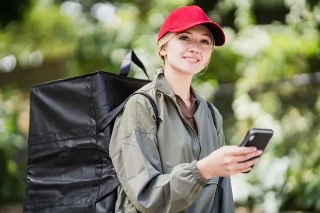 delivery-person-holding-a-phone